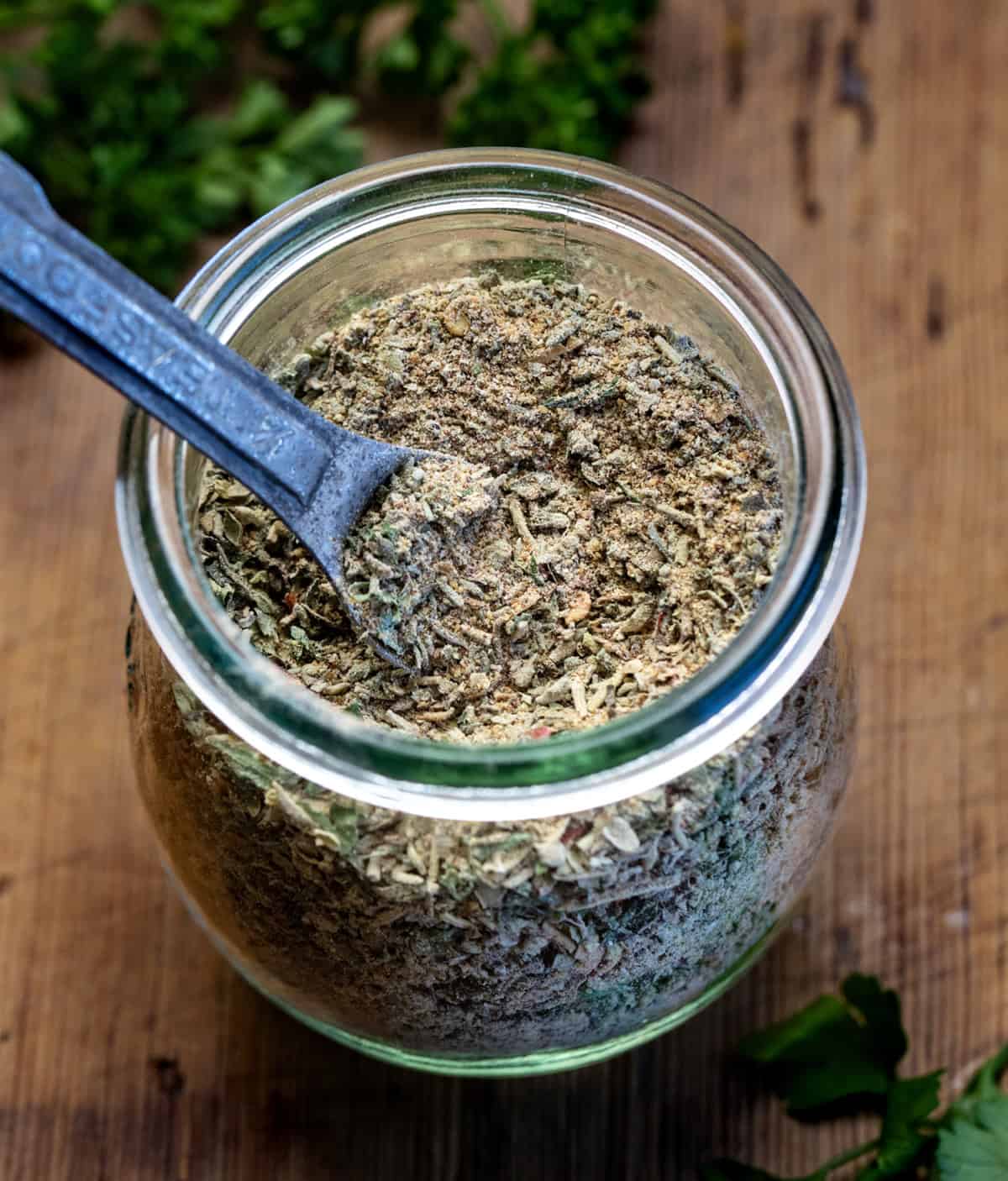 Homemade Tuscan Seasoning is a quick and easy spice blend that adds bold Italian flavor to your favorite meals. It’s made with dried herbs, garlic, and a touch of sun-dried tomato for a rich, savory taste! Jar of Tuscan Seasoning with a metal teaspoon in it.