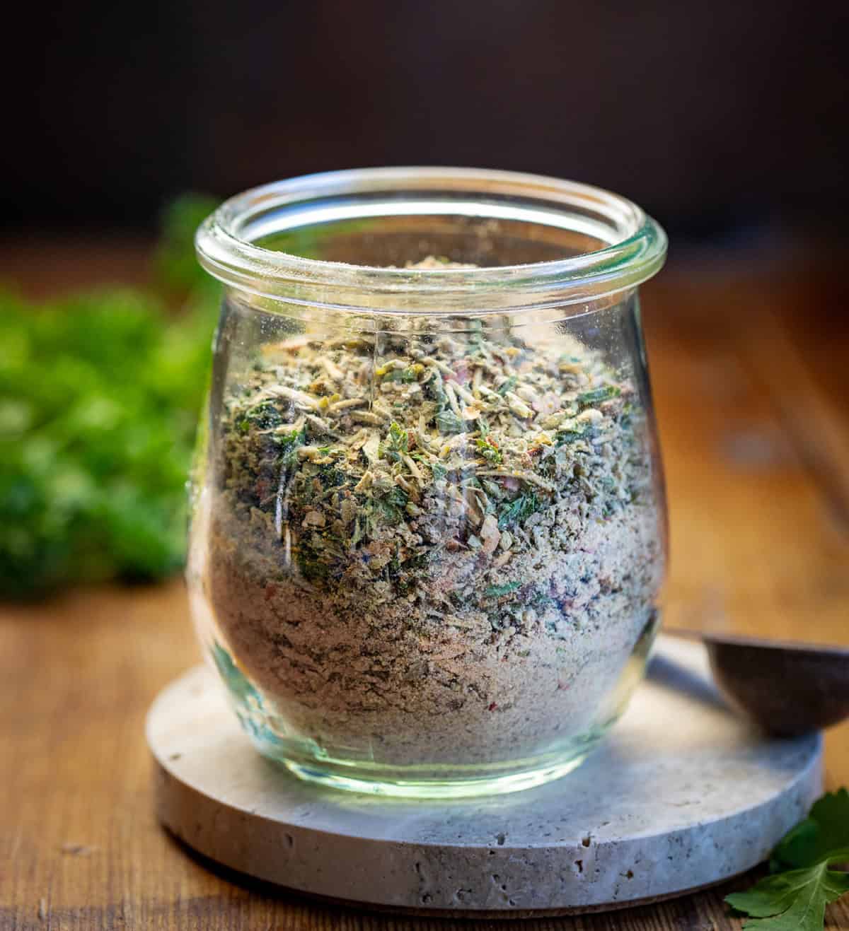 Homemade Tuscan Seasoning is a quick and easy spice blend that adds bold Italian flavor to your favorite meals. It’s made with dried herbs, garlic, and a touch of sun-dried tomato for a rich, savory taste! Jar of Tuscan Seasoning on a wooden table.