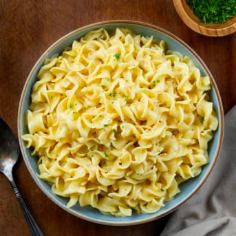 Bowl of Cafeteria Noodles on a wooden table from overhead.