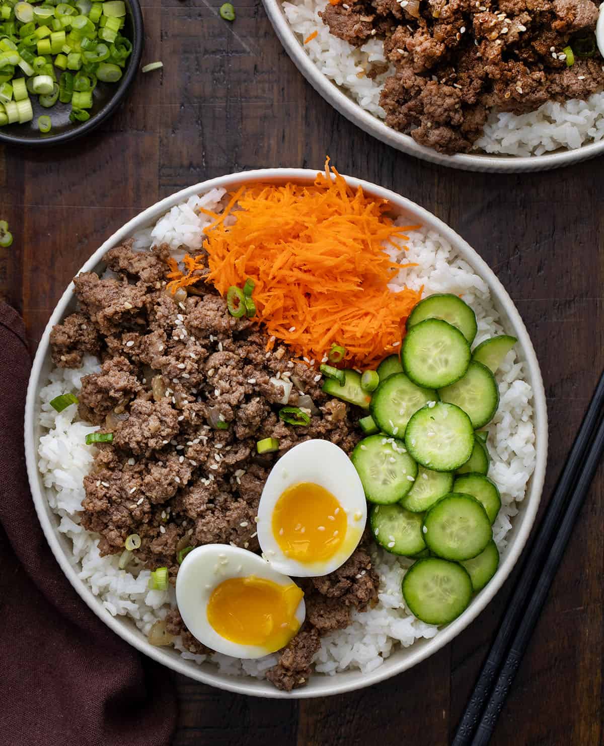 Ground Beef Bulgogi Bowls on a wooden table from overhead.