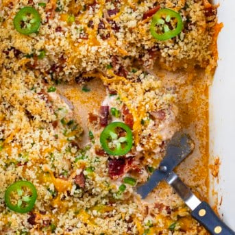 Jalapeño Popper Chicken in a pan with a spatula.