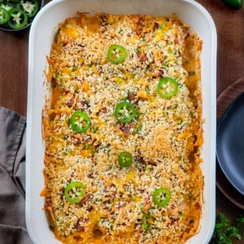 Pan of Jalapeño Popper Chicken on a wooden table from overhead.