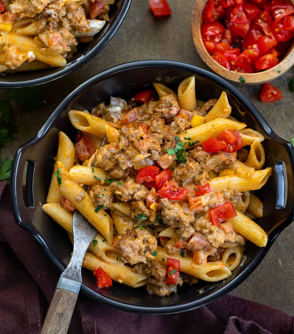 This Southwest Ground Beef Pasta is creamy, cheesy, and full of bold Southwest flavors. Easy to make, flexible with ingredients, and perfect for meal prep! Black bowl filled with Southwest Ground Beef Pasta and a fork in it.