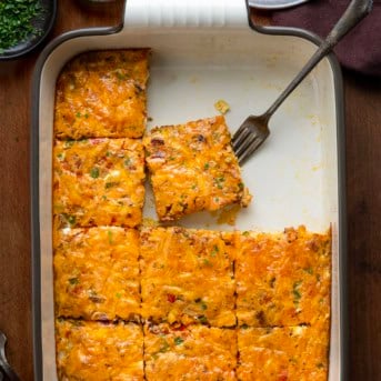 Pan of Western Omelette Breakfast Bake cut into squares with soem pieces missing.