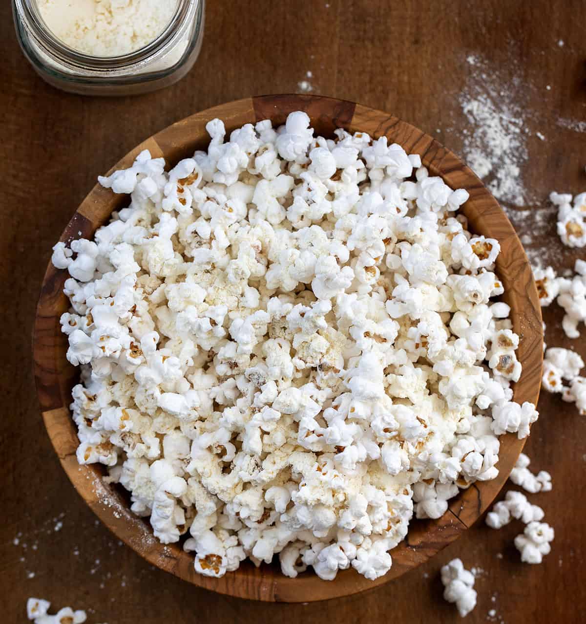 A quick and easy way to make your popcorn cheesy, flavorful, and irresistible. Just mix the spices and cheddar powder, shake on your favorite snack, and enjoy a homemade savory treat that’s ready in minutes! Bowl of white popcorn with White Cheddar Popcorn Seasoning on it and a jar of the seasoning.