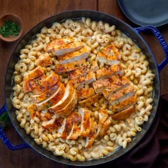 White Cheddar Ranch Chicken Pasta with the chicken cut into slices on a wooden table from overhead.