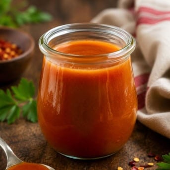Jar of Buffalo Sauce on a wooden table.