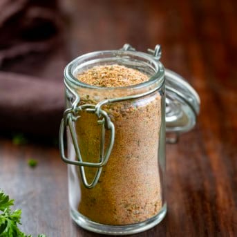 Jar of Cajun Seasoning on a wooden table.