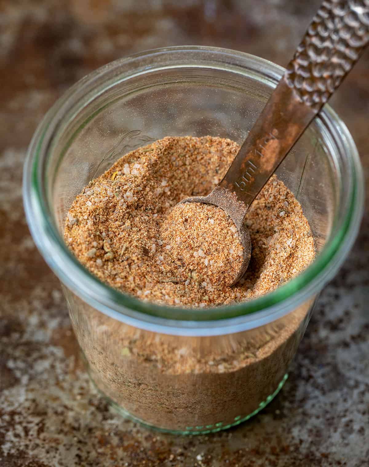 This chicken seasoning is one of those blends I reach for constantly, especially when I want big flavor without overthinking dinner. It’s smoky, savory, slightly sweet, and works on just about any cut of chicken, whether you’re grilling, baking, pan-searing, or air frying. Jar of Chicken Seasoning with a measuring spoon in the jar.