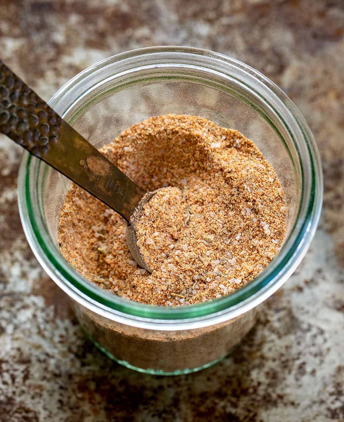 This chicken seasoning is one of those blends I reach for constantly, especially when I want big flavor without overthinking dinner. It’s smoky, savory, slightly sweet, and works on just about any cut of chicken, whether you’re grilling, baking, pan-searing, or air frying. Jar of Chicken Seasoning with a measuring spoon in the jar.