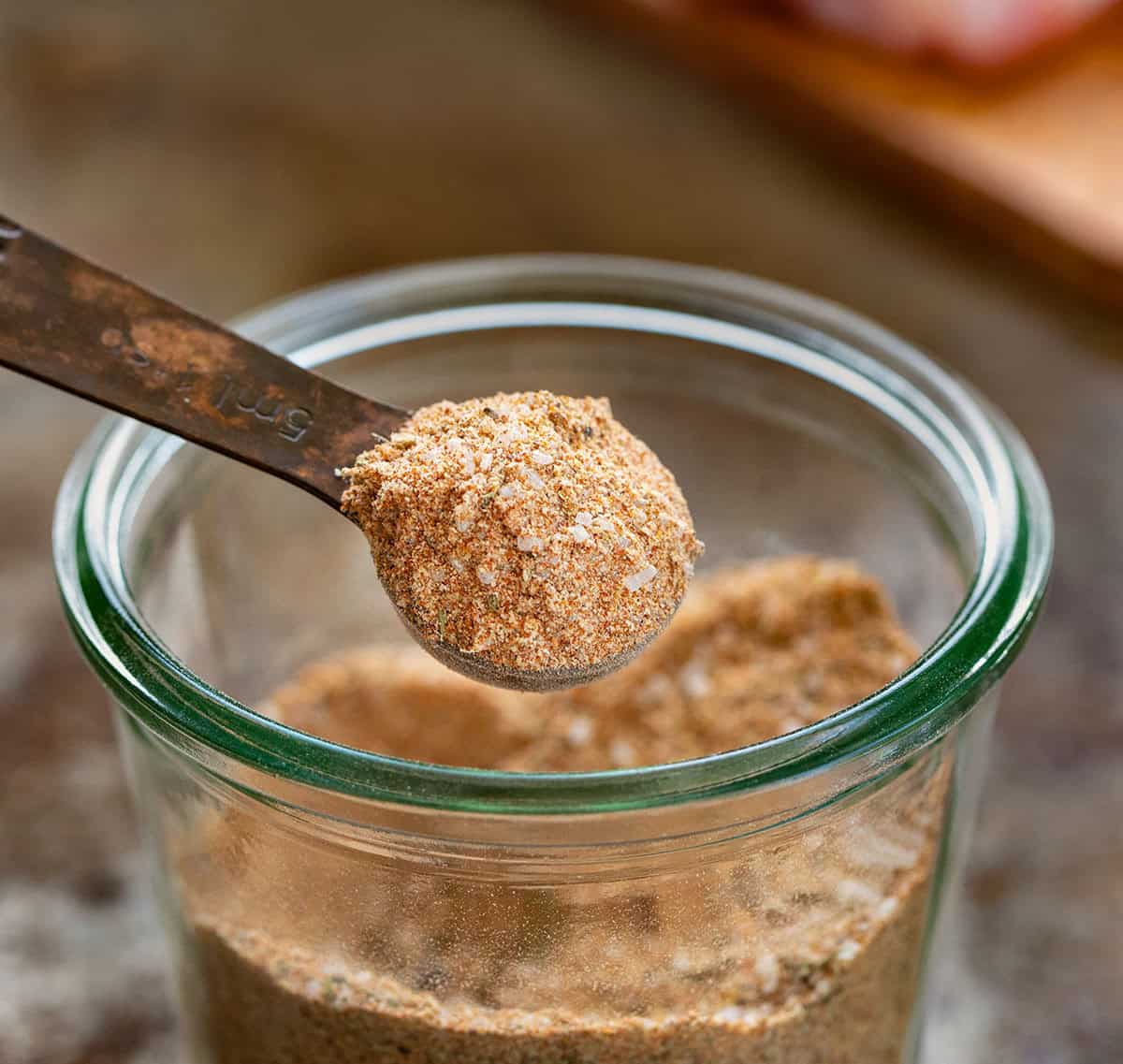 This chicken seasoning is one of those blends I reach for constantly, especially when I want big flavor without overthinking dinner. It’s smoky, savory, slightly sweet, and works on just about any cut of chicken, whether you’re grilling, baking, pan-searing, or air frying. Scoop of Chicken Seasoning on a measuring spoon close up.