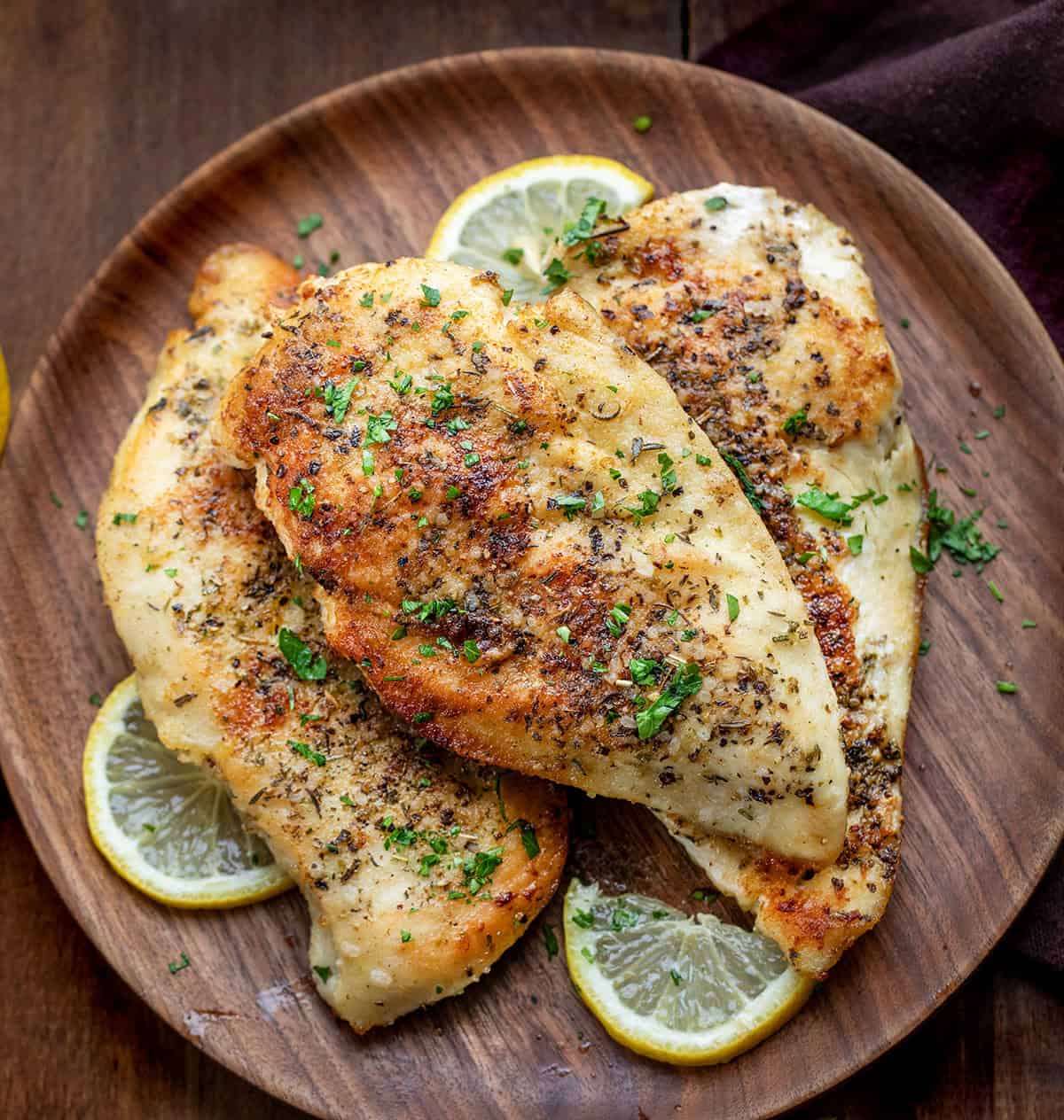Chicken for Lemon Chicken Orzo on a wooden table from overhead Chicken for Lemon Chicken Orzo on a wooden table from overhead.