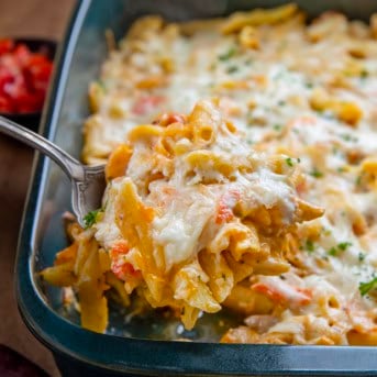 Picking up a scoop of Seafood Pasta Bake from the pan.