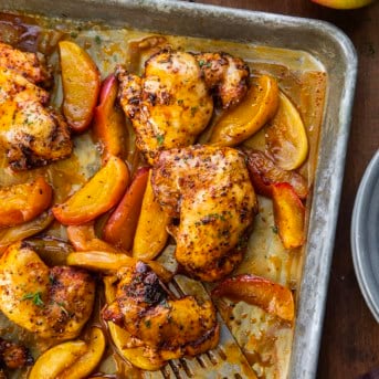 Sheet Pan Apple Chicken on a wooden table from overhead.