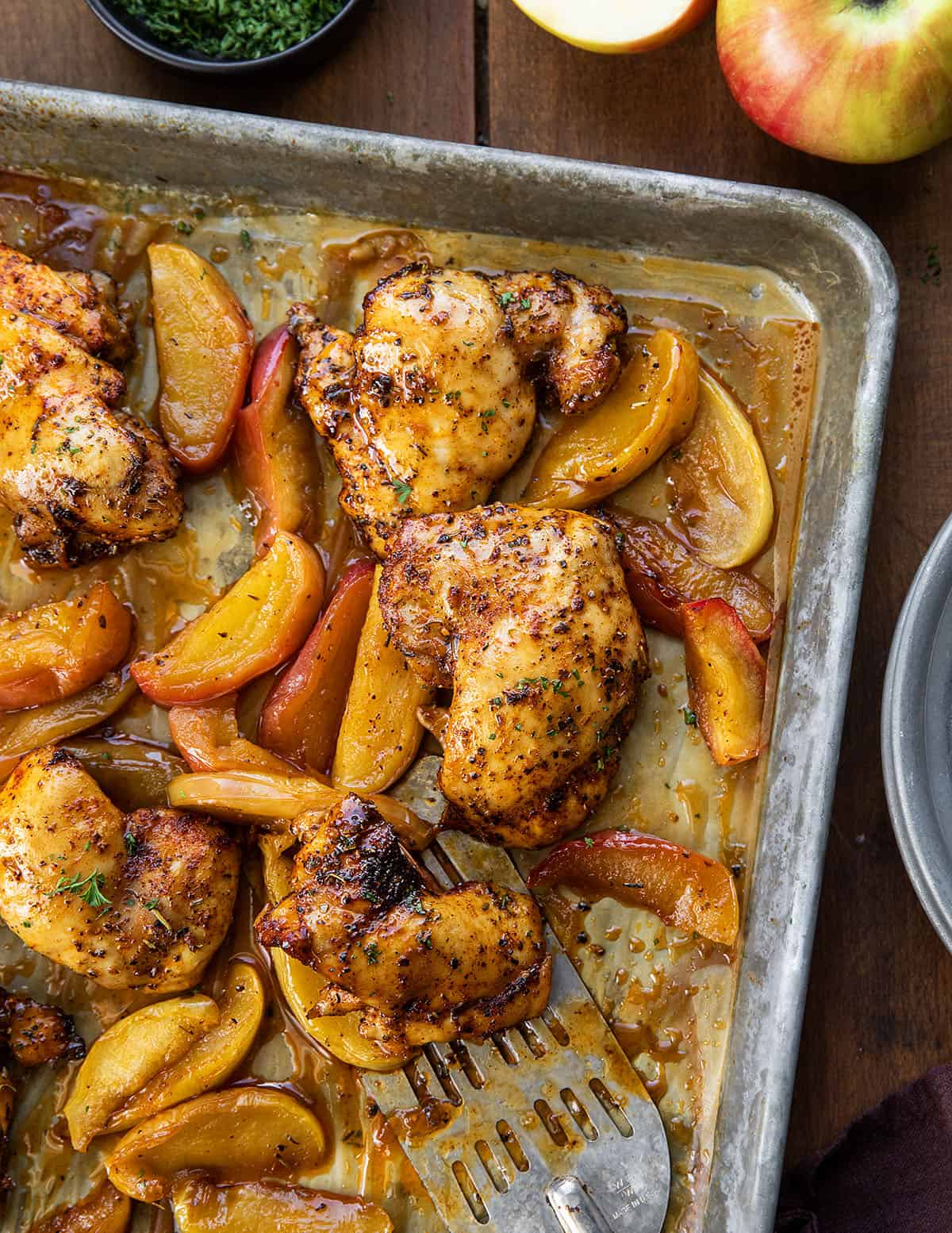 Sheet Pan Apple Chicken on a wooden table from overhead.