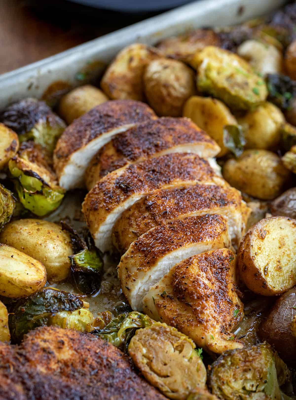 Sliced Blackened Chicken and Brussels Sprouts close up in the pan Sliced Blackened Chicken and Brussels Sprouts close up in the pan.
