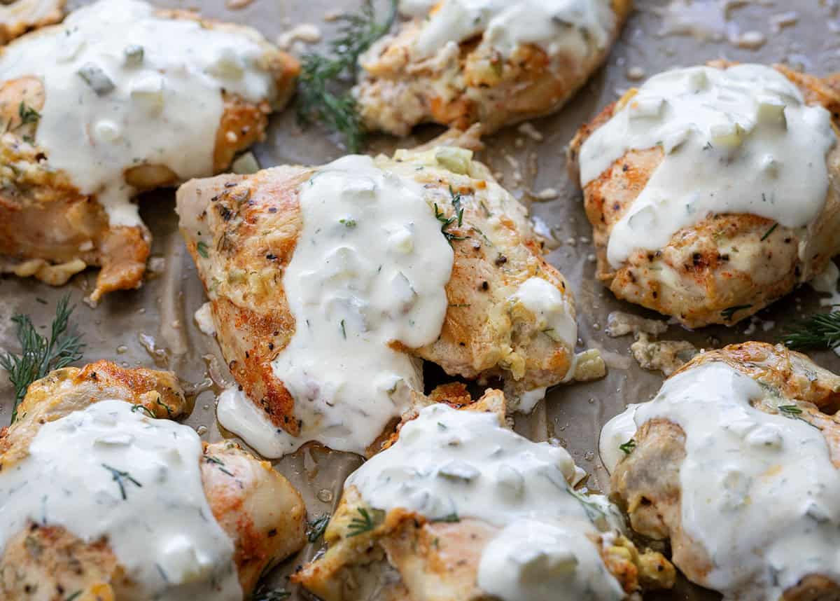 If you love pickles and ranch, this Dill Pickle Ranch Chicken is about to be your new obsession! Juicy chicken thighs are soaked in dill pickle juice for maximum tang and tenderness, then brushed with my creamy homemade Dill Pickle Ranch Dressing and cooked until perfectly golden! Dill Pickle Ranch Chicken drizzled with dill pickle ranch dressing.