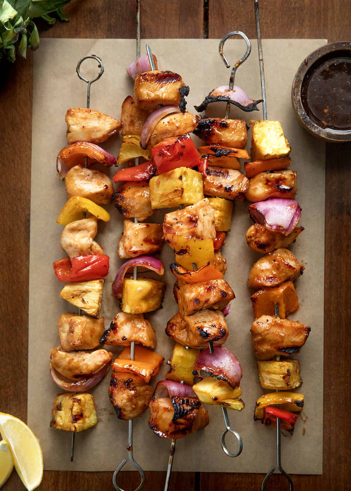 Hawaiian Chicken Skewers on a wooden table from overhead Hawaiian Chicken Skewers on a wooden table from overhead.