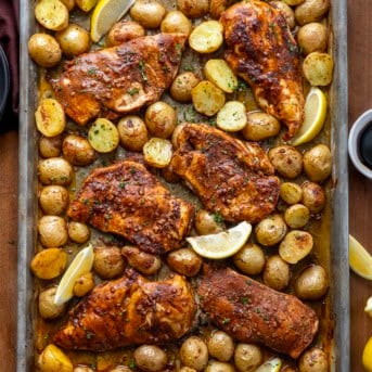 Lemon Balsamic Chicken and Potatoes on a sheet pan on a wooden table from overhead.