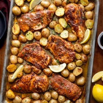 Lemon Balsamic Chicken and Potatoes on a sheet pan on a wooden table from overhead.