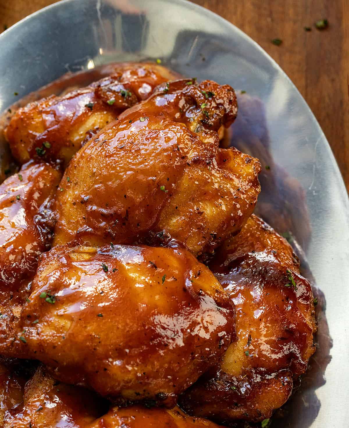 CLose up of Oven Baked BBQ Chicken Thighs showing how juicy and perfectly cooked they are.