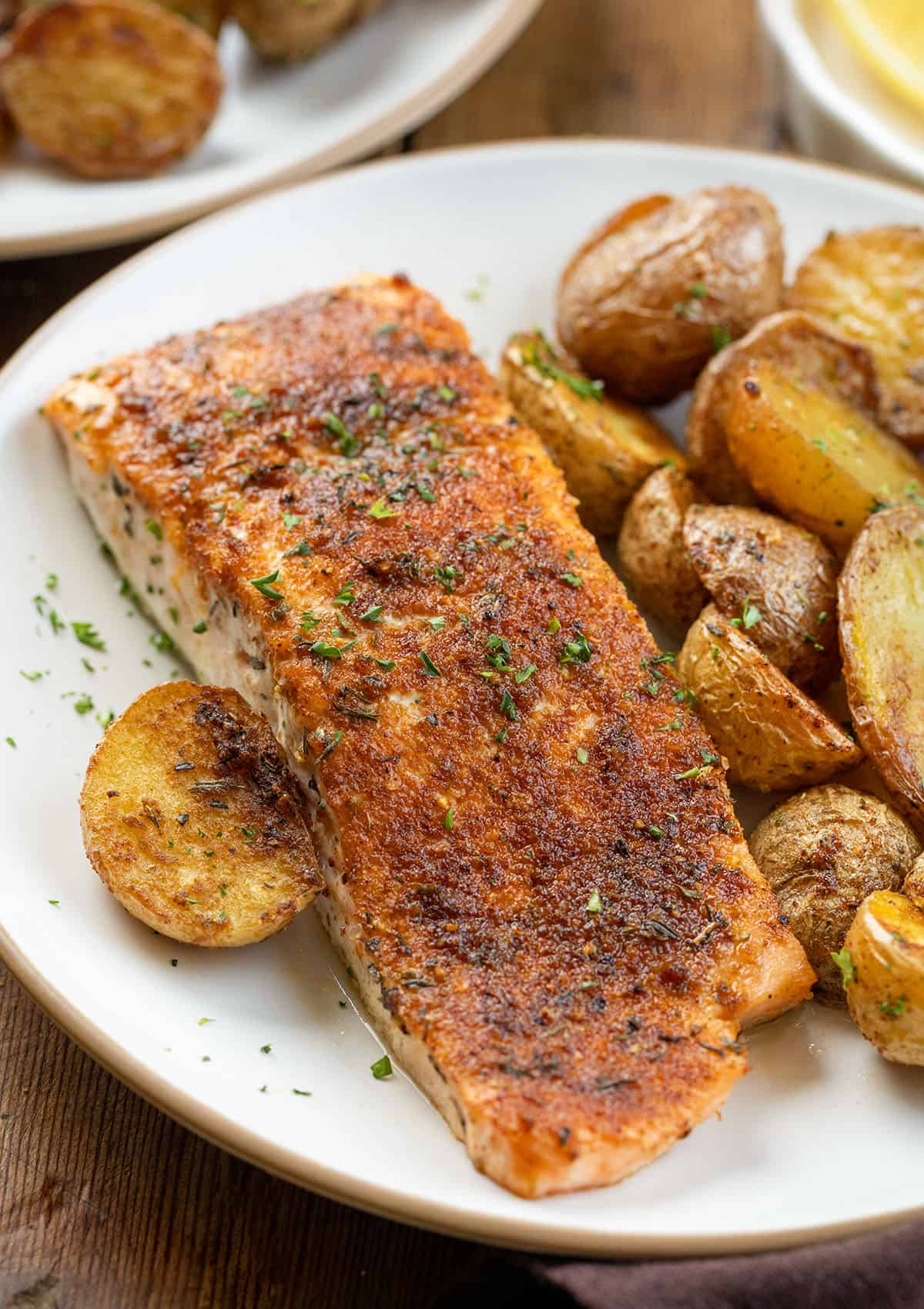 Close up of smokey salmon on a plate with crispy potatoes Close up of smokey salmon on a plate with crispy potatoes.