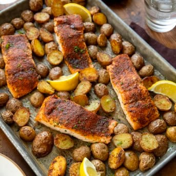 Sheet Pan of Salmon and Crispy Potatoes on a wooden table.