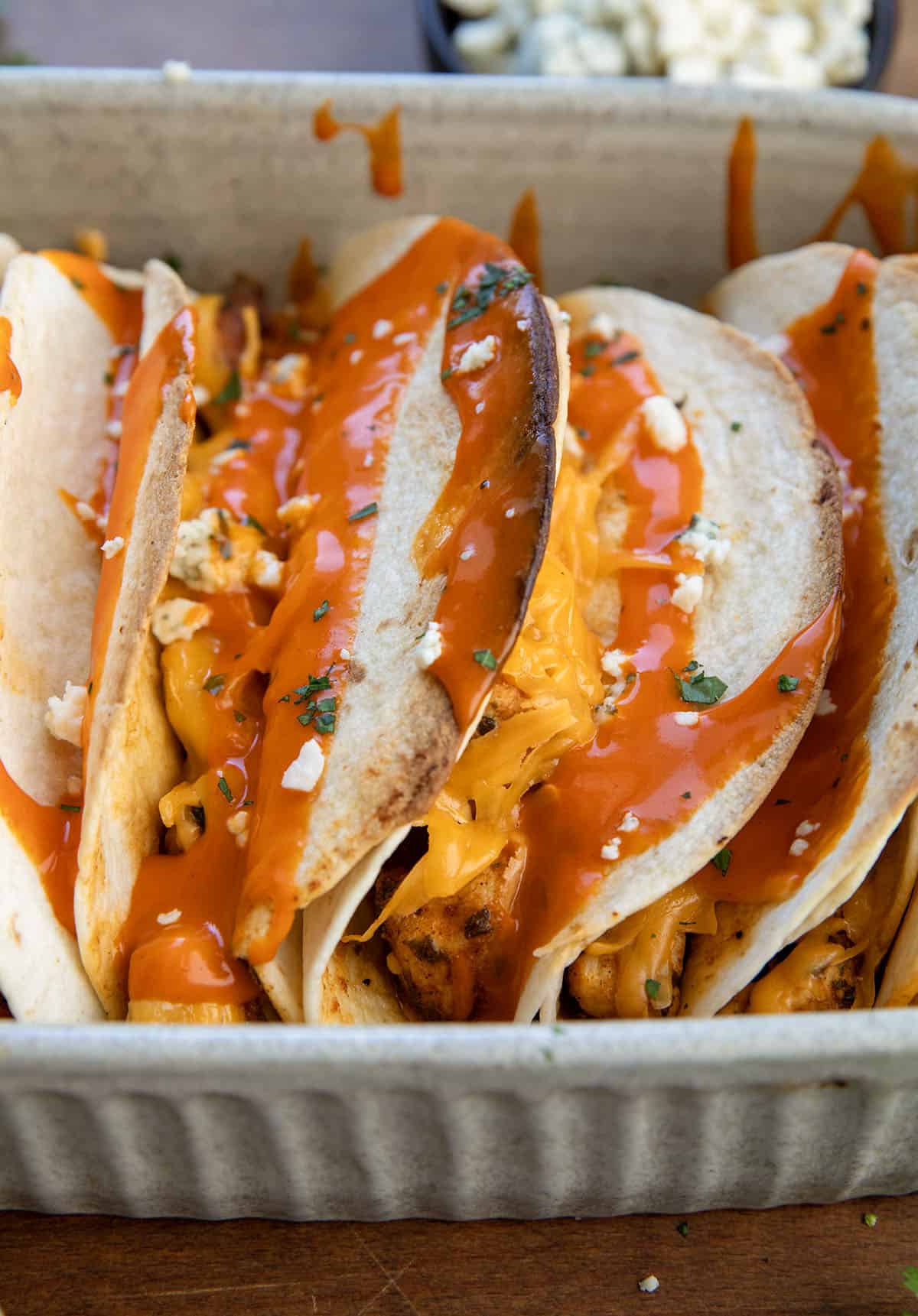 Close up of Baked Buffalo Chicken Tacos in a baking dish Close up of Baked Buffalo Chicken Tacos in a baking dish.