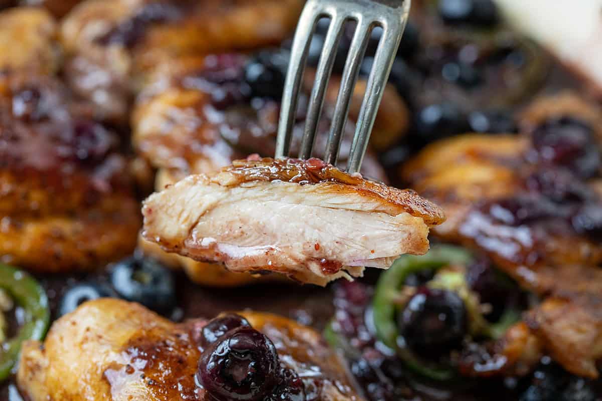 Cut into piece of Blueberry Jalapeño Chicken showing the tender, juicy chicken Cut into piece of Blueberry Jalapeño Chicken showing the tender, juicy chicken.