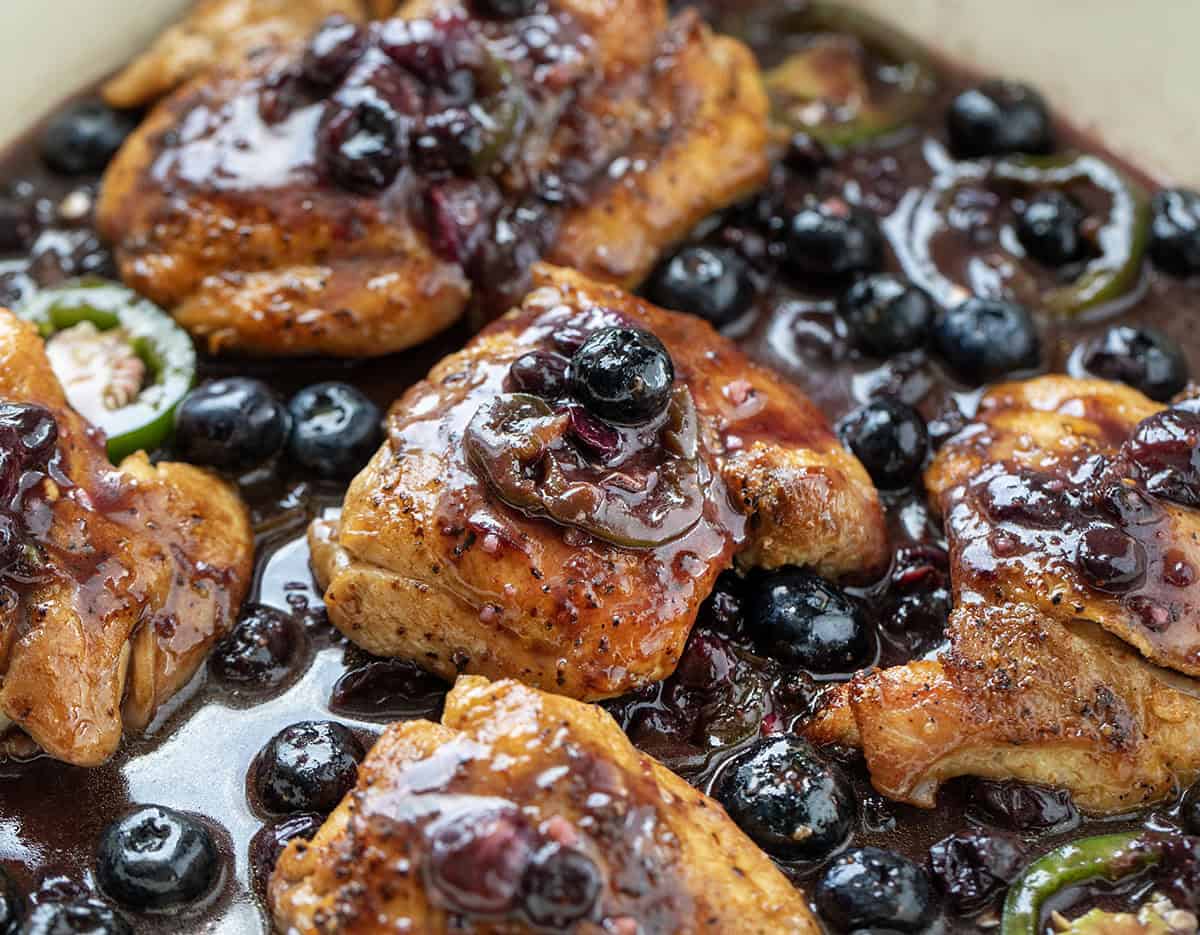 Blueberry Jalapeño Chicken coated in sauce and nestled in a skillet Blueberry Jalapeño Chicken coated in sauce and nestled in a skillet.