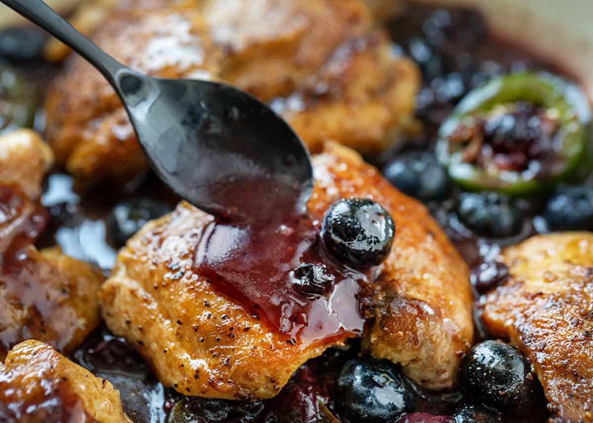 Spooning sauce over chicken for Blueberry Jalapeño Chicken Spooning sauce over chicken for Blueberry Jalapeño Chicken.