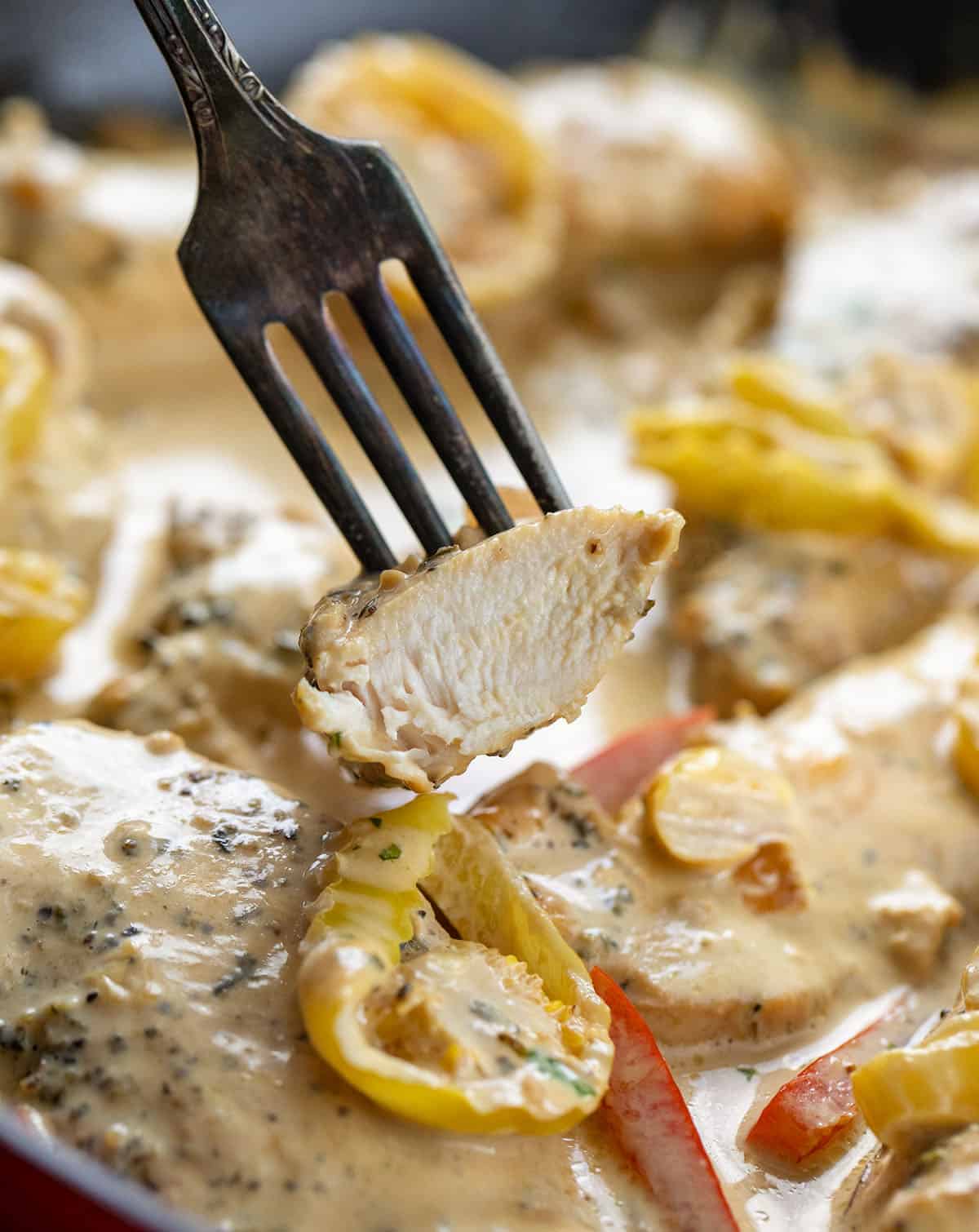 Fork with a piece of Creamy Pepperoncini Chicken Skillet on it showing how juicy and tender the chicken is Fork with a piece of Creamy Pepperoncini Chicken Skillet on it showing how juicy and tender the chicken is.