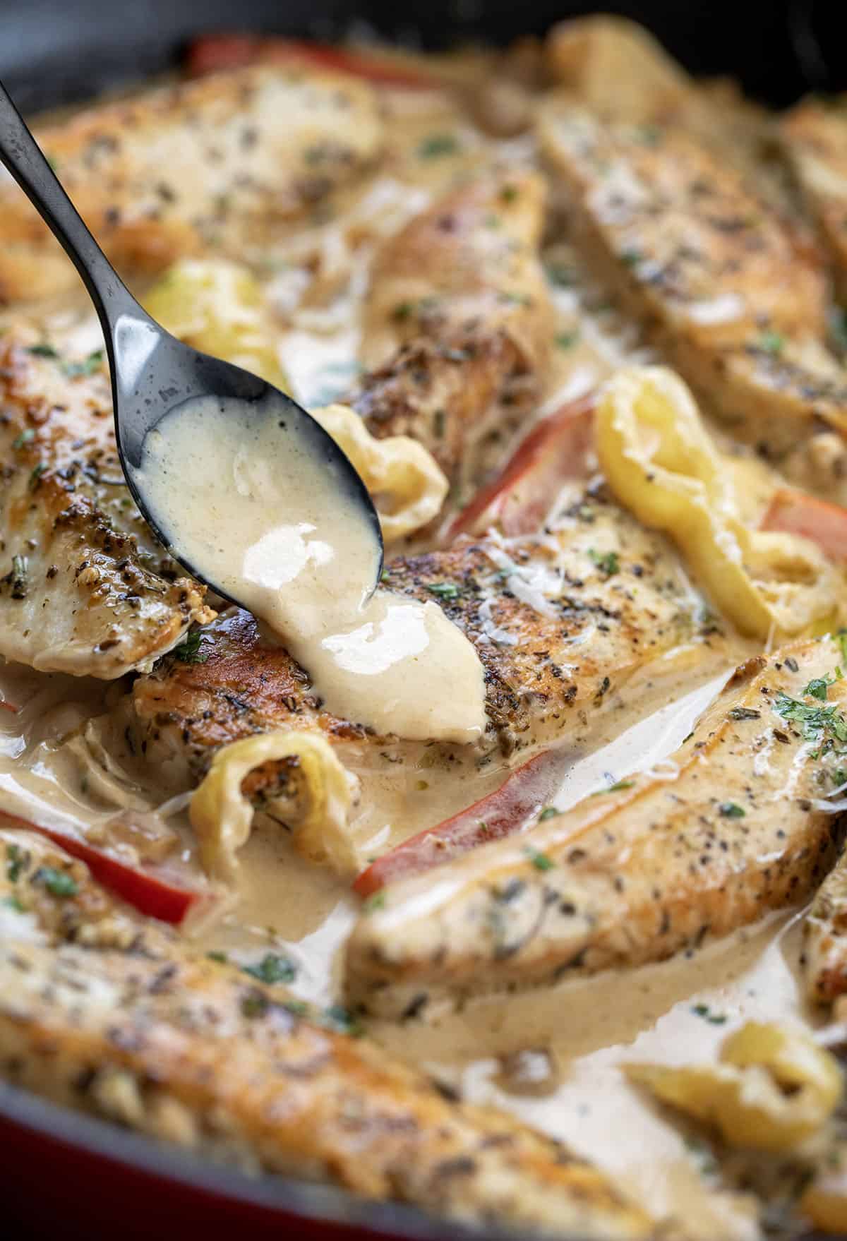 Spooning sauce over a piece of chicken in a Creamy Pepperoncini Chicken Skillet Spooning sauce over a piece of chicken in a Creamy Pepperoncini Chicken Skillet.