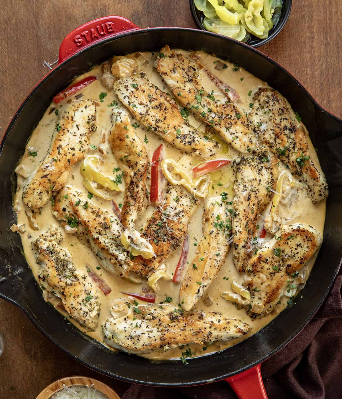 Creamy Pepperoncini Chicken Skillet on a wooden table from overhead Creamy Pepperoncini Chicken Skillet on a wooden table from overhead.