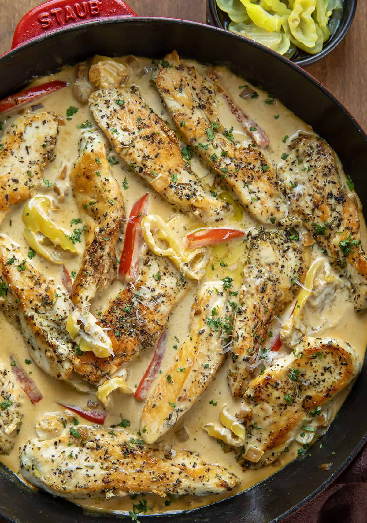 Creamy Pepperoncini Chicken Skillet on a wooden table from overhead Creamy Pepperoncini Chicken Skillet on a wooden table from overhead.
