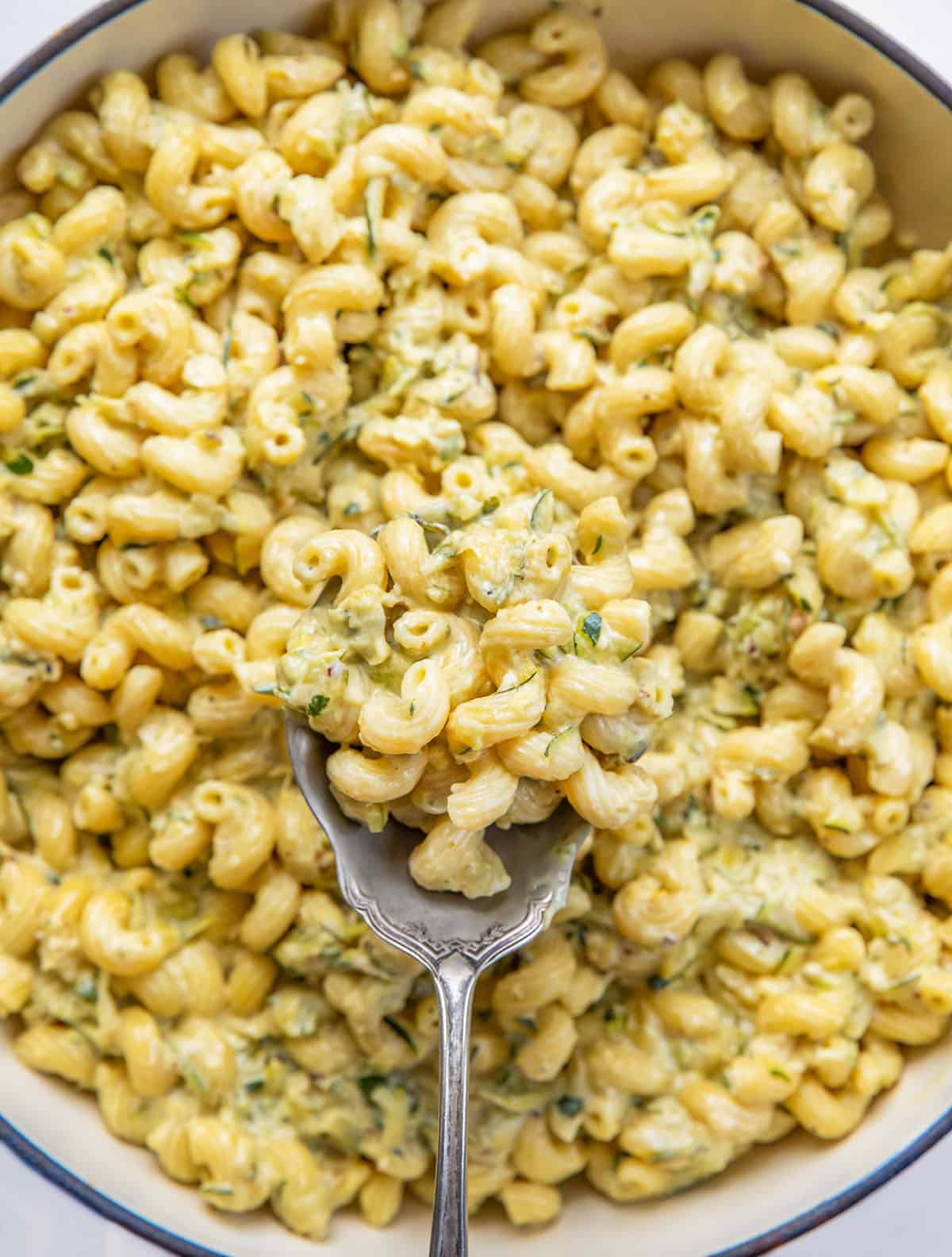 Spoonful of Garlic Lemon Zucchini Pasta being held above the skillet Spoonful of Garlic Lemon Zucchini Pasta being held above the skillet.