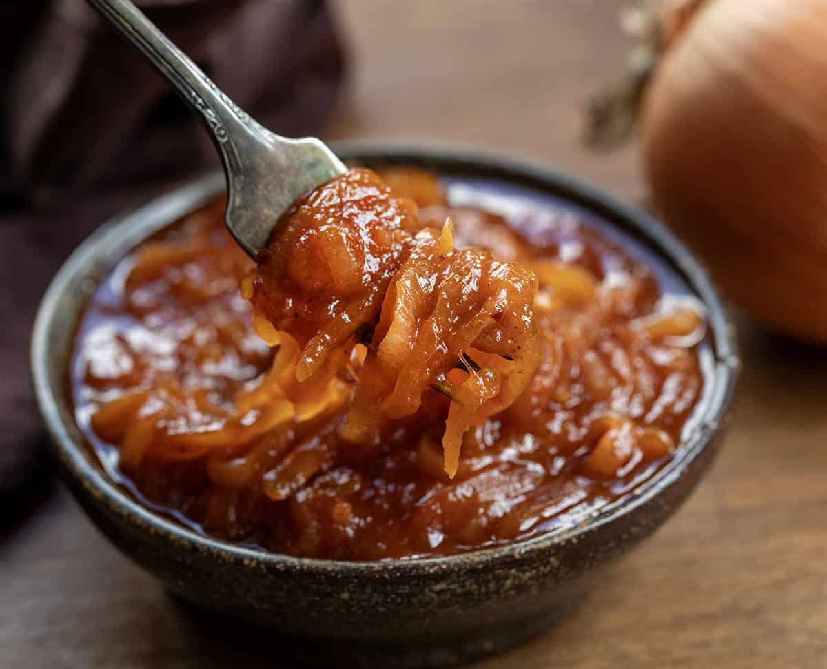 Fork picking up some Hot Dog Onion Sauce from a bowl close up Fork picking up some Hot Dog Onion Sauce from a bowl close up.