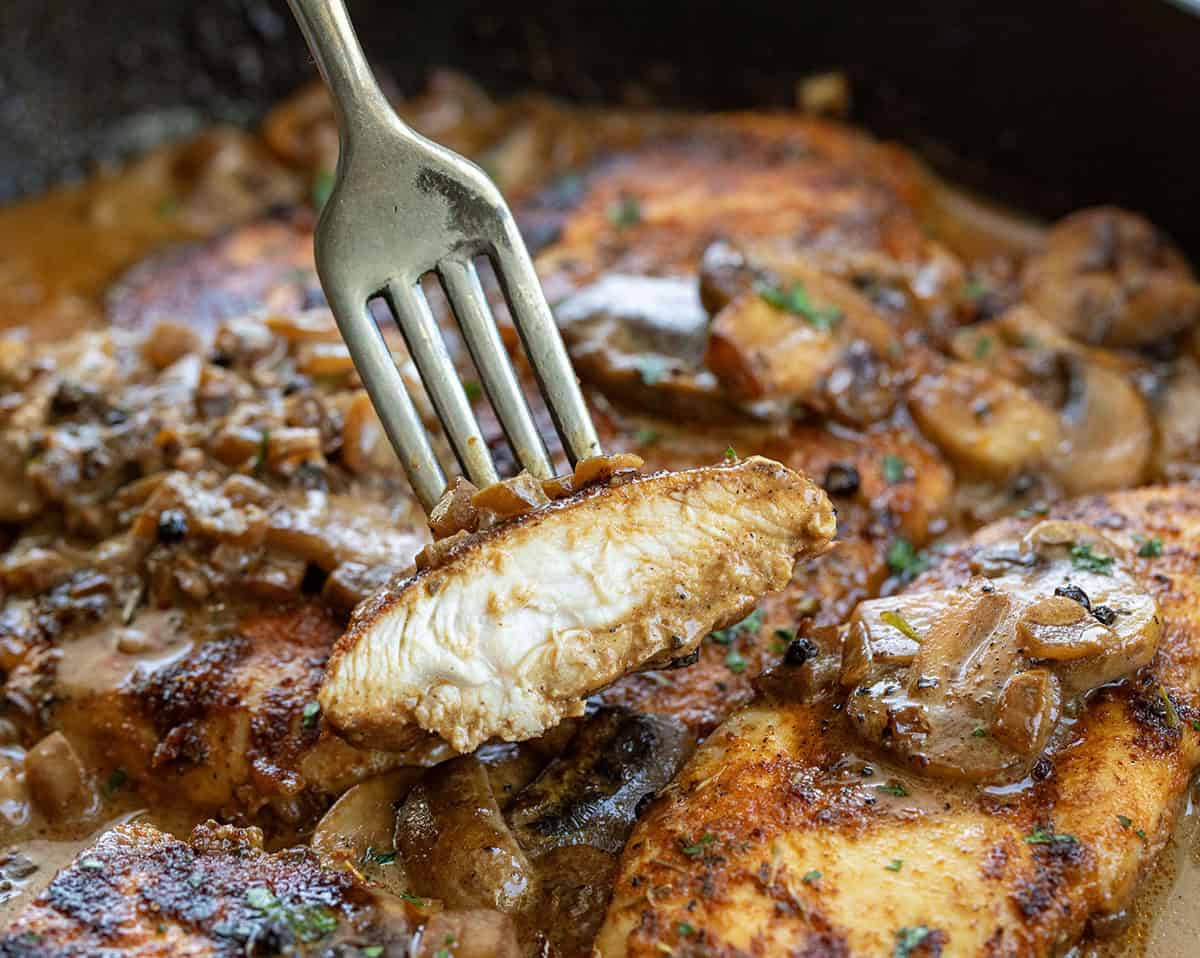 Fork with a piece of Mushroom Peppercorn Chicken on it Fork with a piece of Mushroom Peppercorn Chicken on it.