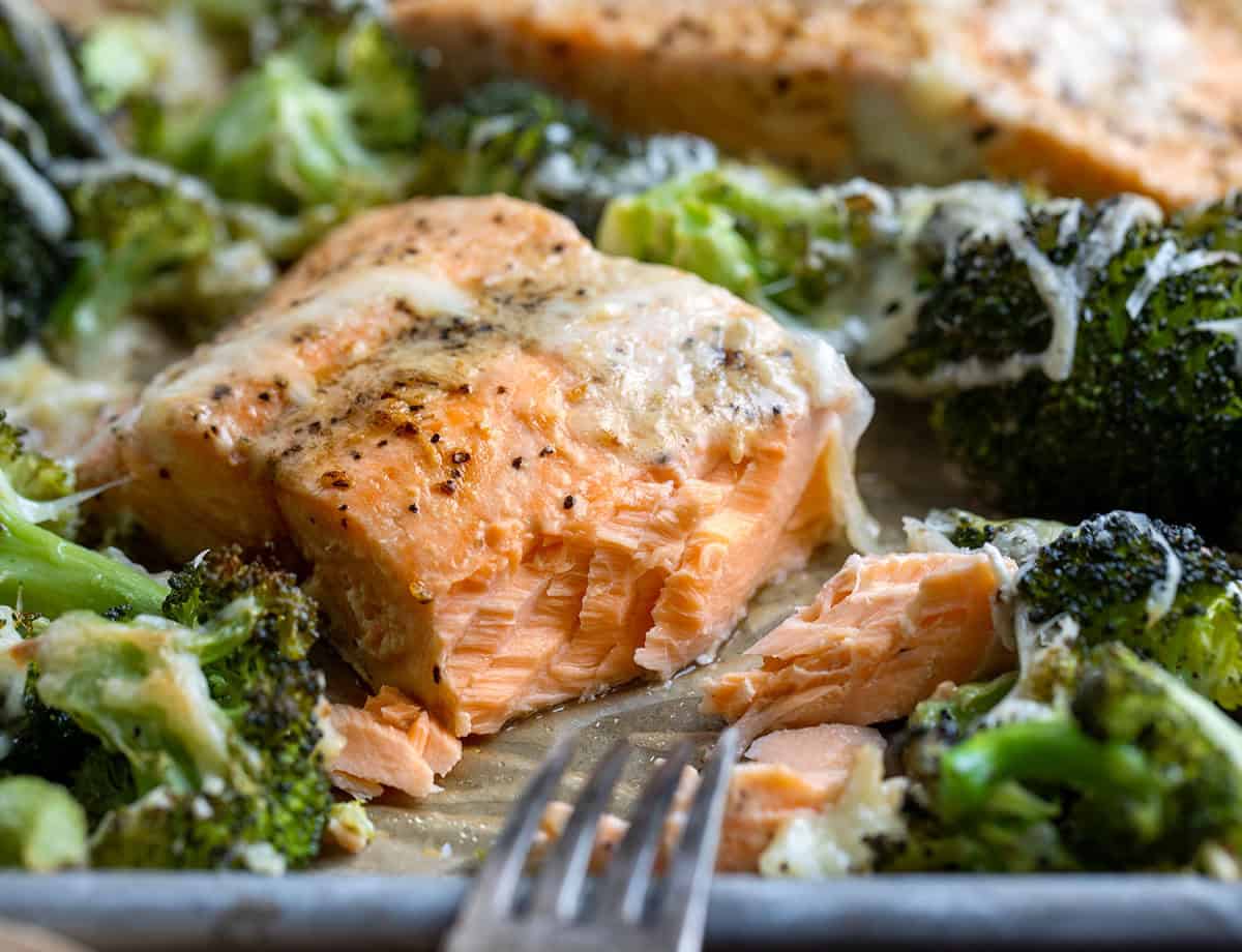 One piece of One Pan Baked Caesar Salmon with some of the salmon removed showing the flakey texture One piece of One Pan Baked Caesar Salmon with some of the salmon removed showing the flakey texture.