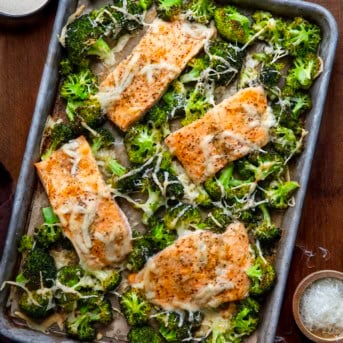 One Pan Baked Caesar Salmon on a wooden table from overhead.