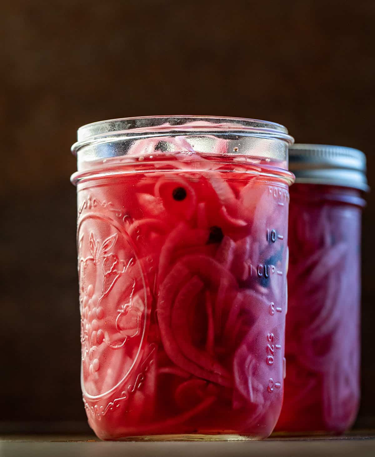Chilled jars of Pickled Red Onions on a wooden table Chilled jars of Pickled Red Onions on a wooden table.