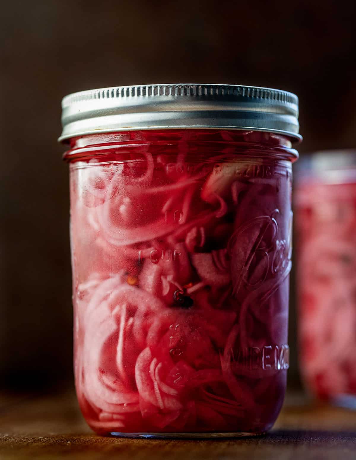 Jars of Pickled Red Onions on a wooden table Jars of Pickled Red Onions on a wooden table.