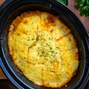 Slow Cooker Cornbread Cowboy Casserole on a wooden table from overhead.