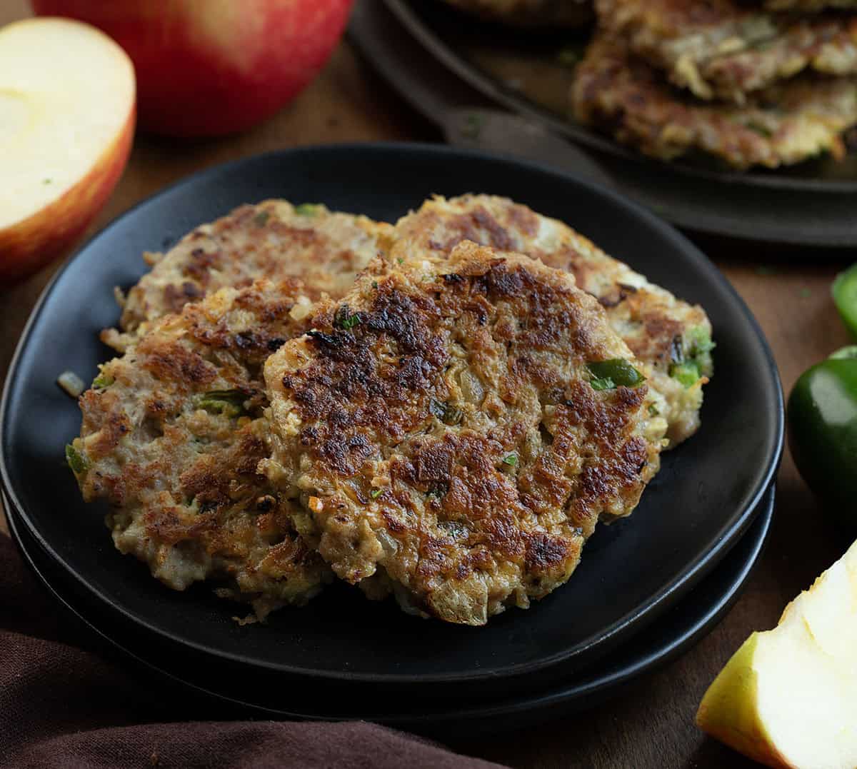 Black plate with Apple Jalapeño Breakfast Sausage Patties on it close up Black plate with Apple Jalapeño Breakfast Sausage Patties on it close up.