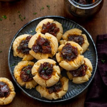 Tray of Bacon Jam Cheddar Thumbprint Cookies on a wooden table from overhead.
