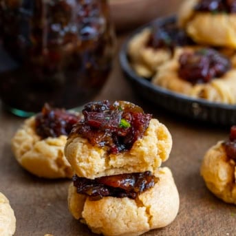 Bacon Jam Cheddar Thumbprint Cookies with the top cookie bit into showing the inside texture.