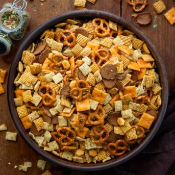 Cowboy Butter Chex Mix in a big wooden bowl on a wooden table from overhead.