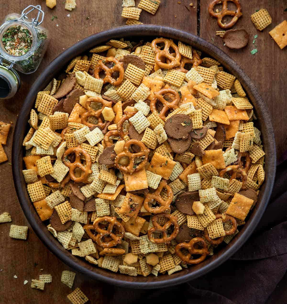 Cowboy Butter Chex Mix in a big wooden bowl on a wooden table from overhead Cowboy Butter Chex Mix in a big wooden bowl on a wooden table from overhead.