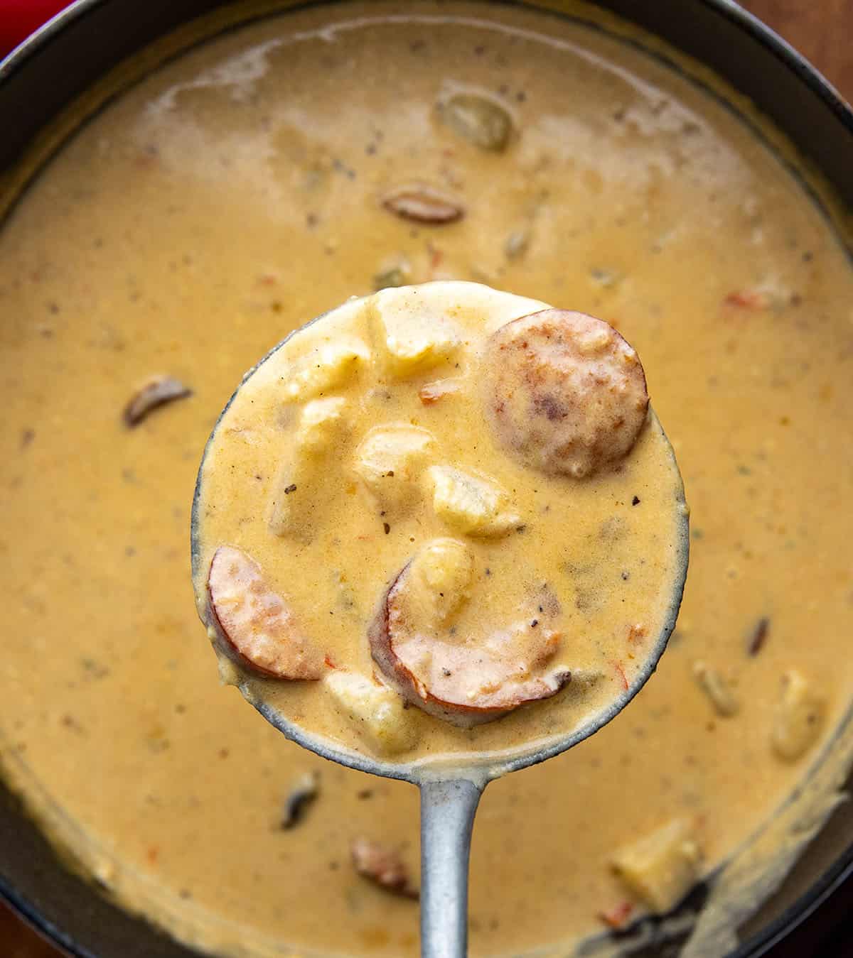 Ladle full of Creamy Cajun Potato Soup being held above the pot Ladle full of Creamy Cajun Potato Soup being held above the pot.