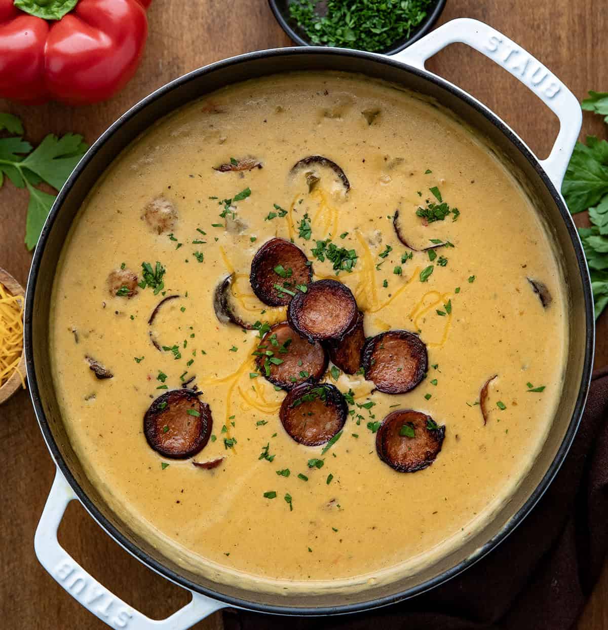 Pot of Creamy Cajun Potato Soup on a wooden table from overhead Pot of Creamy Cajun Potato Soup on a wooden table from overhead.